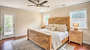 A bedroom with a wooden bed, a ceiling fan, and two bedside tables with lamps. - Wooded Pottsboro Escape ~ 1 Mi to Lake Texoma (Pottsboro)