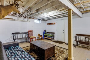 A room with a wooden bench, a rocking horse, a sofa, and a patterned rug. - Rustic Adirondacks Home w/ Hot Tub & Lake Access! (Chestertown)