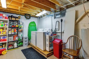 A laundry room with a washing machine, dryer, and various cleaning supplies. - Rustic Adirondacks Home w/ Hot Tub & Lake Access! (Chestertown)