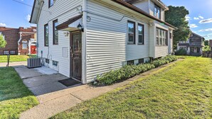 A two-story house with a front porch, a visible chimney, and a small front yard. - Lovely Milwaukee Getaway - Family Friendly! (Milwaukee)