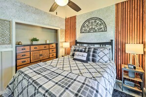 A bedroom with a bed, a dresser, a clock, and a wall clock. - Hot Tub & Deck: Pet-friendly Home in Payson (Payson)