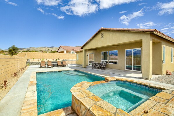 Relax by the inviting pool surrounded by a patio with outdoor furniture.