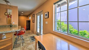 A kitchen with a large window, a countertop, and a chair. - Paradise Valley Cottage Near Hiking Trails! (Paradise Valley)