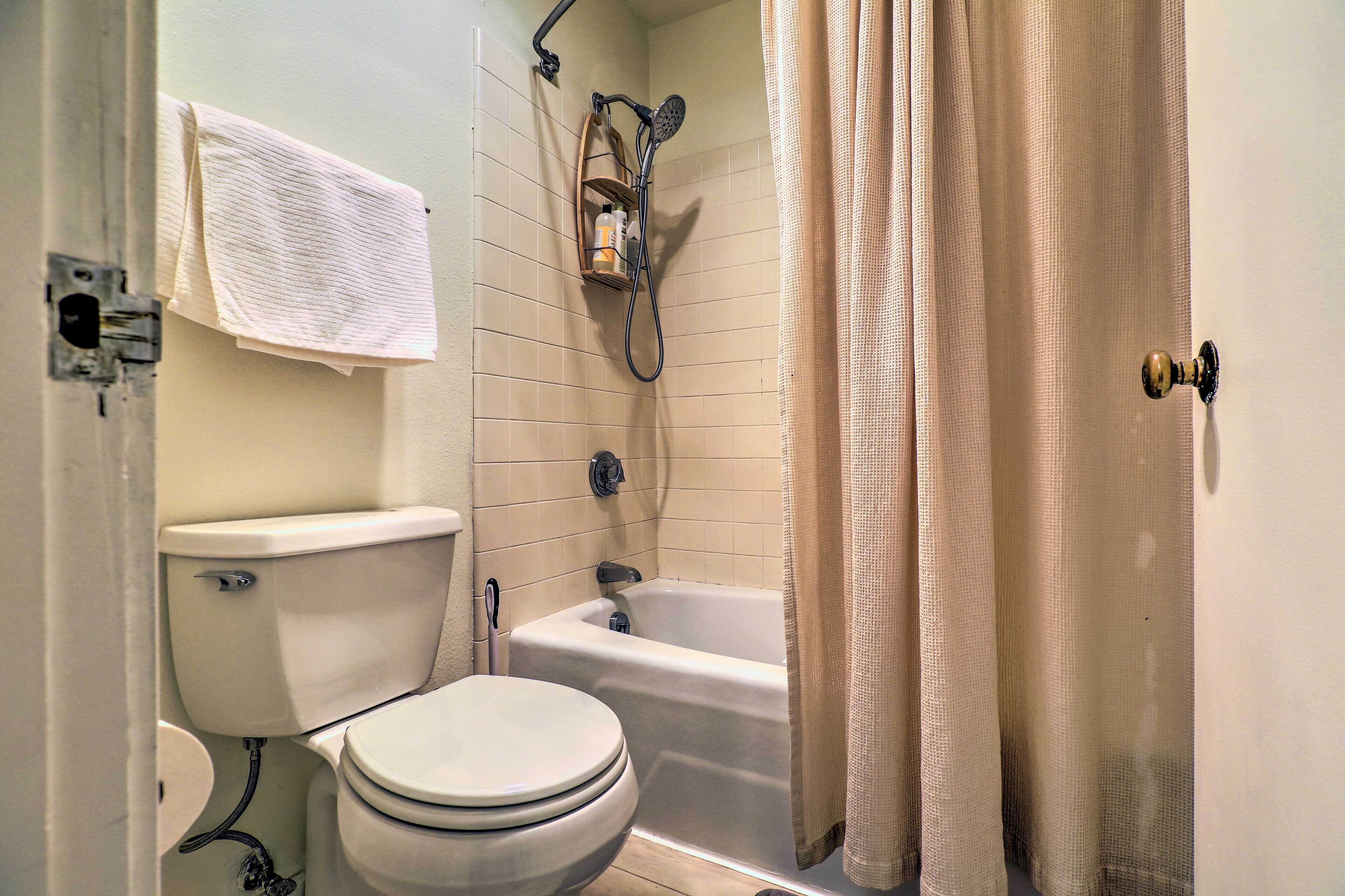 A bathroom with a toilet, sink, and bathtub.