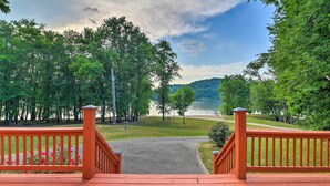 A wooden deck with a metal railing leading to a path. - Ohio River Views: Home w/ Fireplace & Deck! (Wolf Creek)