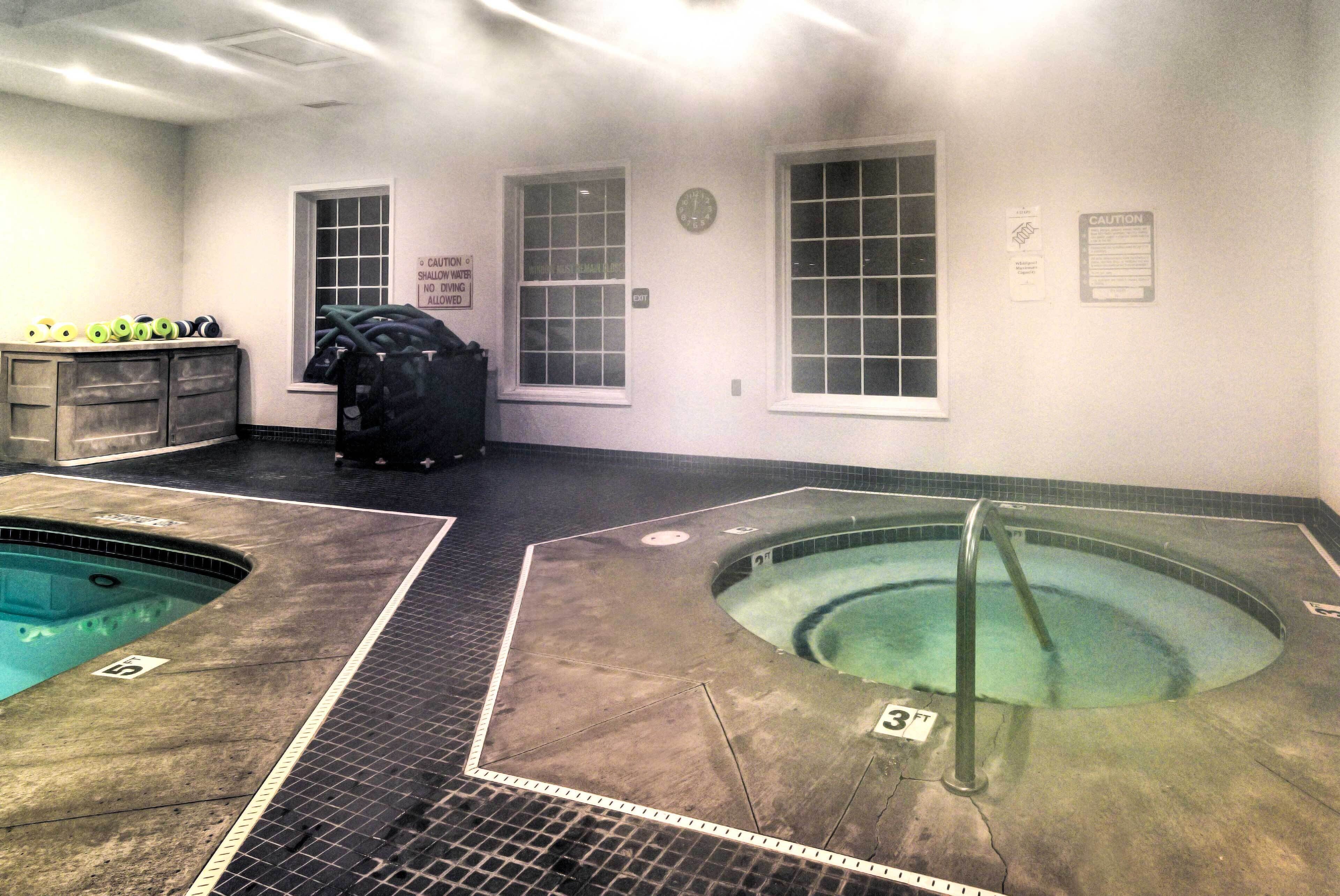 A pool area with two pools, a changing room, and a caution sign.
