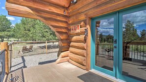 A wooden cabin with a sign reading "WELCOME TO OUR COLORADO HOME".