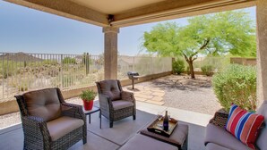 An outdoor patio with wicker furniture, a ceiling fan, and a view of a fenced area with trees and a hill. - Walk to Trails: Mtn-view Mesa Getaway w/ Gril (Mesa)