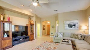 A spacious living room with a flat-screen TV, a ceiling fan, and a large window. - Walk to Trails: Mtn-view Mesa Getaway w/ Gril (Mesa)