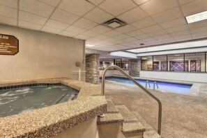 A pool area with a hot tub, stone pillars, and a staircase leading to the pool. - Mtn Condo w/ Ski Locker & Pools - 3 Mi to Resort! (Winter Park)