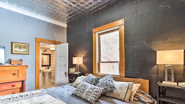 A bedroom with a bed, bedside tables, a dresser, a window, and a door. - Lovely Montrose Home w/ Yard: Walk to Dtwn & Park! (Montrose)