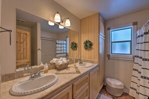 A bathroom with two sinks, a large mirror, and a shower curtain. - Spacious Pinetop Country Club Cabin w/ Deck! (Pinetop)