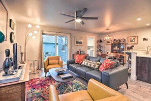A modern living room with a sofa, coffee table, and a dining area with chairs and a table. - Quiet Home by Dtwn Livingston: Hike, Fish & Ski! (Livingston)