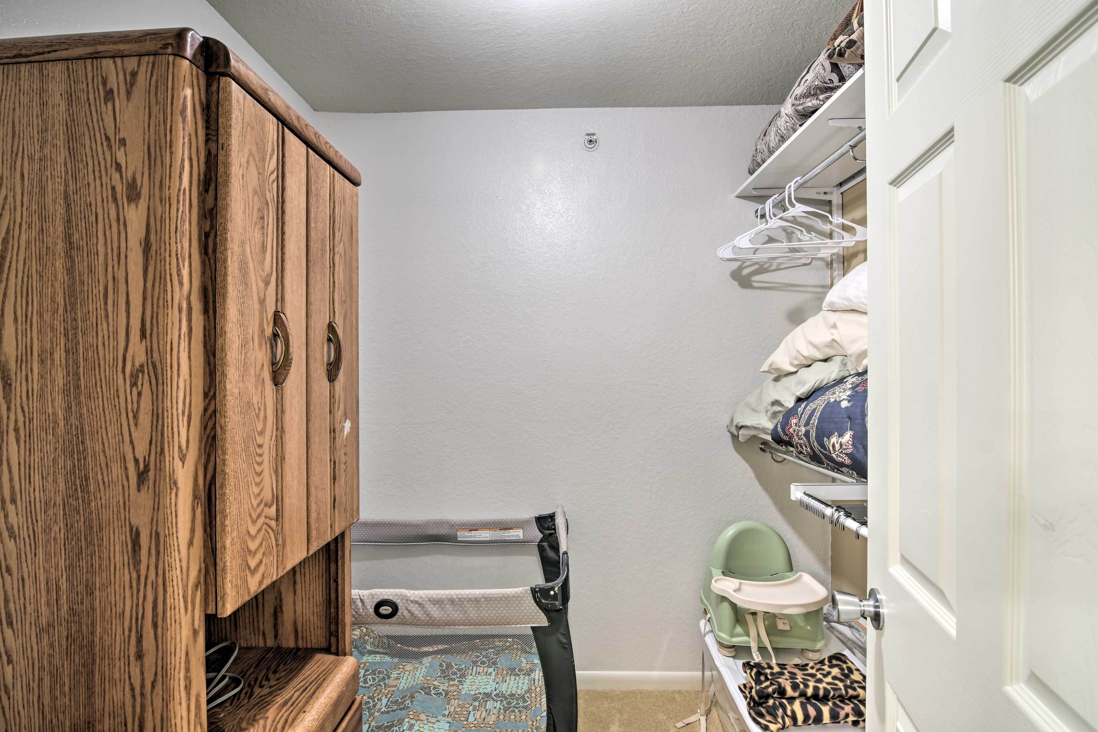 A small, compact bathroom with a wooden cabinet, a shower area, and a toilet.