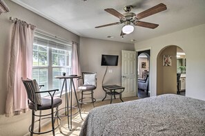 A bedroom with a bed, a ceiling fan, a TV, and a window with curtains. - Holiday Hills Resort Condo w/ Hot Tub Access (Branson)