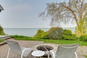 Relax in a serene outdoor space surrounded by lush greenery and a clear view of the water.