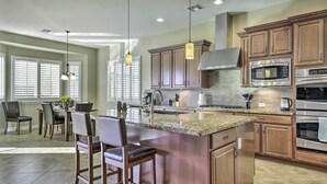 A modern kitchen with granite countertops, stainless steel appliances, and wooden cabinetry. - Updated Goodyear Escape: Remote-work Friendly (Goodyear)