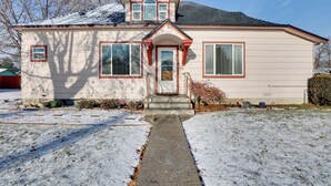 A two-story house with a front porch, a snow-covered lawn, and a clear sky. - 'the Diamond Bungalow' - Cozy Caldwell Home! (Caldwell)