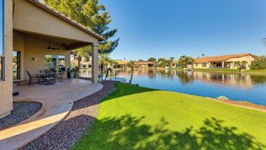 A house with a patio, a swimming pool, and a view of other houses. - Private Patio & Grill: Lakefront Chandler Home (Chandler)