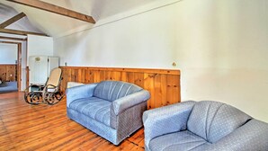 A room with wooden floors, a wooden wall panel, and a white ceiling. - Lakefront Rumney Retreat w/ Shared Dock & Beach! (Rumney)