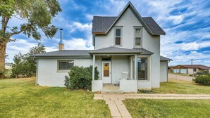 A two-story house with a front porch, a chimney, and a well-maintained lawn. - Charming Trinidad Home ~ 2 Mi to Main Street! (Trinidad)