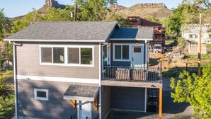 A two-story house with a balcony, a garage, and a small front yard. - Golden Cottage Near Red Rocks & School of Mines! (Golden)