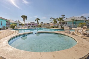 A clear swimming pool with lounge chairs and a wooden deck. - Coastal Gulf Shores Getaway - Near the Beaches! (Gulf Shores)