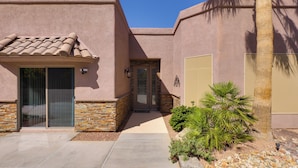 A stucco building with a tiled roof, stone accents, and a palm tree. - Infinity Pool & Lake Views: Havasu Group Escape (Lake Havasu City)