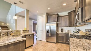 A modern kitchen with granite countertops, stainless steel appliances, and wooden flooring. - Family Home w/ Deck, 3 Mi to Downtown Flagstaff! (Flagstaff)
