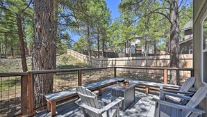 A deck with Adirondack chairs, a fire pit, and a wooden table. - Family Home w/ Deck, 3 Mi to Downtown Flagstaff! (Flagstaff)