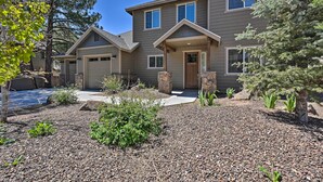 A two-story house with a stone entrance, a garage, and a well-maintained garden with gravel and plants. - Family Home w/ Deck, 3 Mi to Downtown Flagstaff! (Flagstaff)