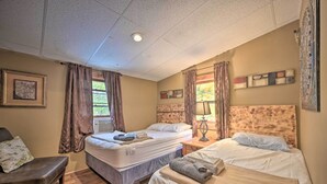 A hotel room with two beds, a bench, and a ceiling light. - 1 Mi to Raystown Lake: Bill Pickett Ranch Apt (Huntingdon)