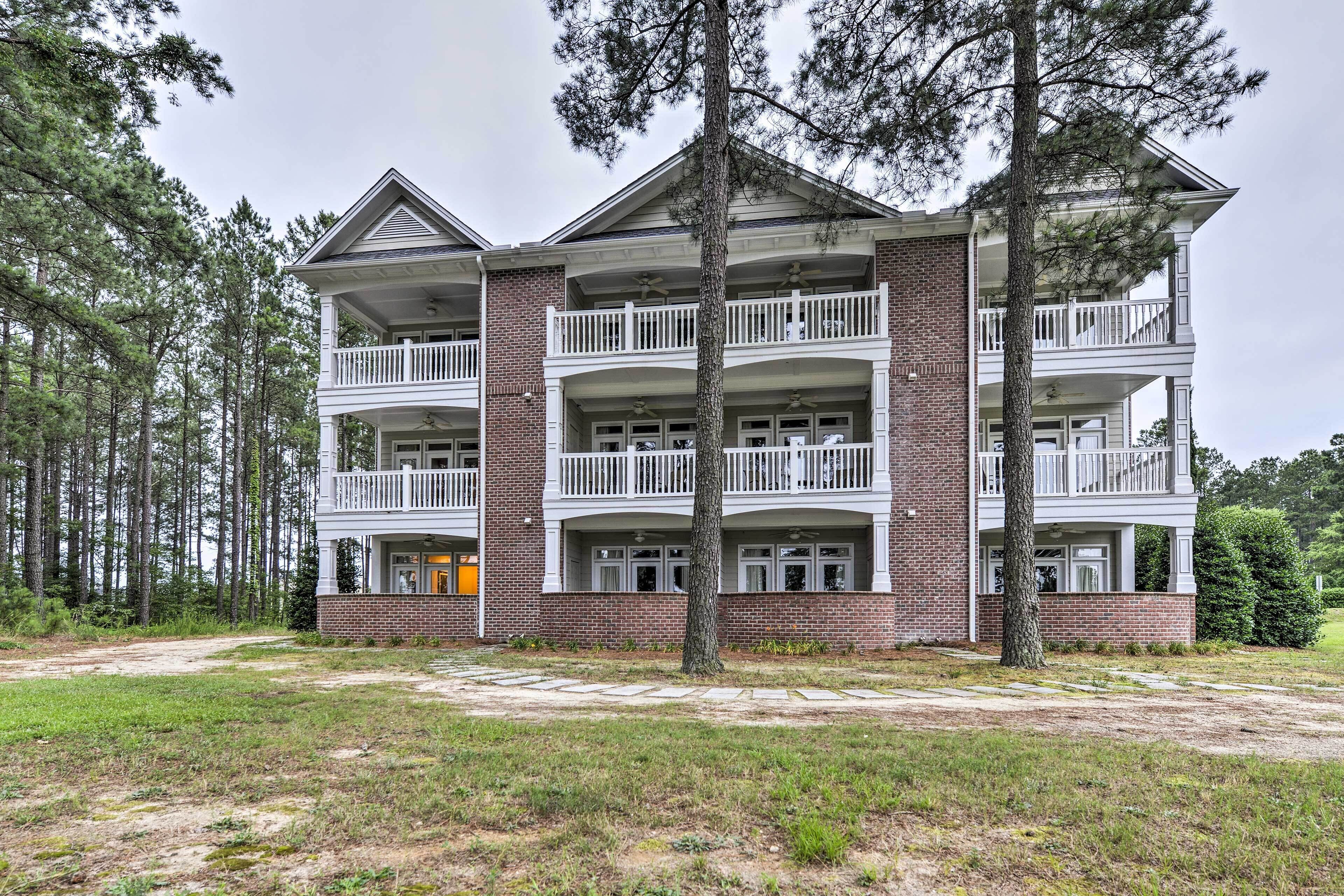A multi-story building with a brick facade and white balconies.