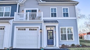 A two-story house with a front garage, a balcony, and a dark front door. - 2 Mi to Bethany Beach: Family-friendly Home! (Ocean View)