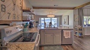 A kitchen with a large stove, a refrigerator, and a sink. There is a window with a view of the outdoors. - Dock & Grand Lake Access! Idyllic Afton Getaway (Afton)