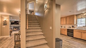 A modern kitchen with wooden cabinets, a built-in oven, and a window overlooking the outdoors. - 4 Mi to Woodland Lake: 2-story Home w/ Grill (Pinetop)