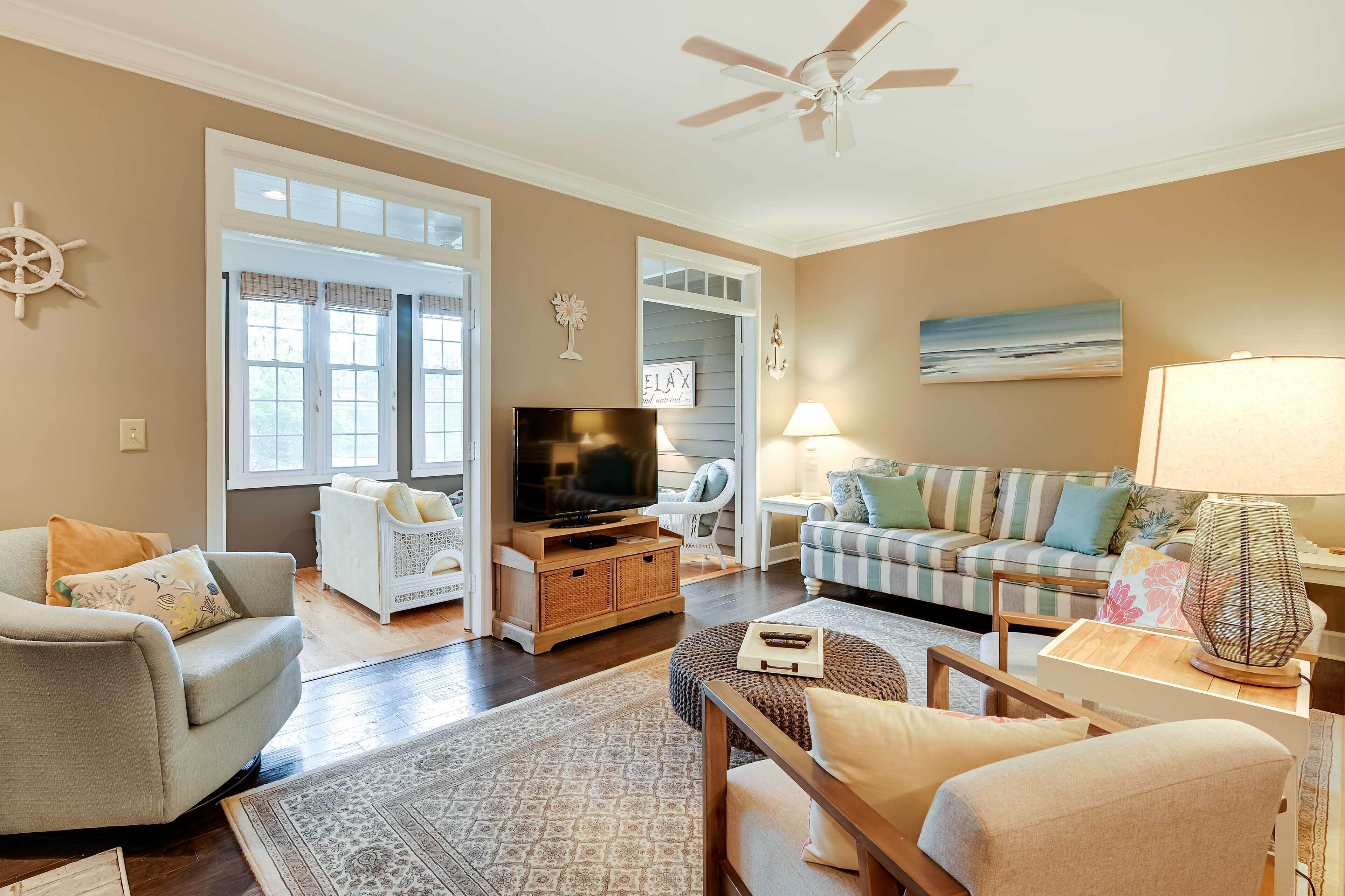 A living room with a television, sofa, and a lamp.