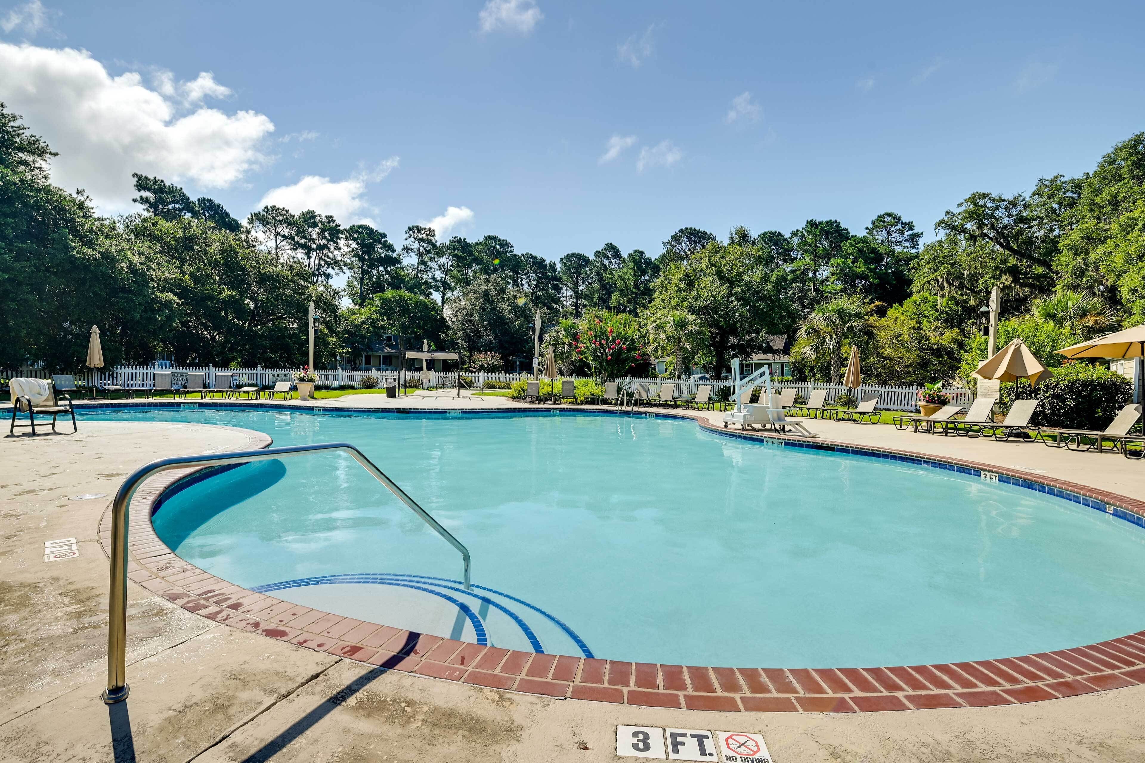 A swimming pool with a brick border and a no diving sign.