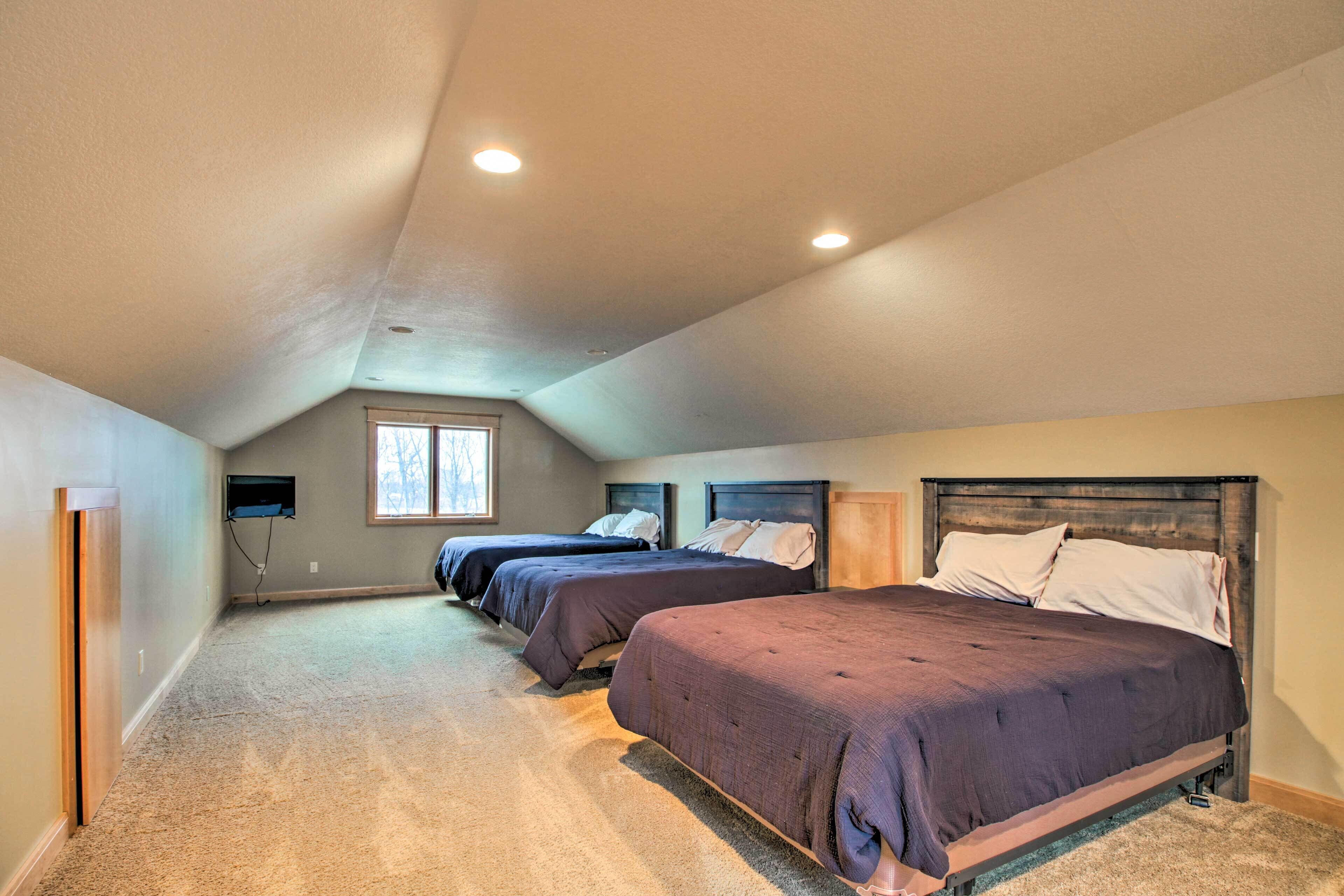 A bedroom with two beds, a window, and a ceiling fan.