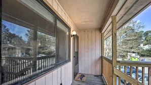 A wooden porch with a view of parked cars and a UPS truck outside. - Updated Wilmington Retreat ~ 2 Miles to Uncw! (Wilmington)