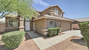 A single-story house with a tiled roof, a front door, and a garage. - 2 Mi to Goodyear Ballpark! Home w/ Poolside Oasis (Goodyear)