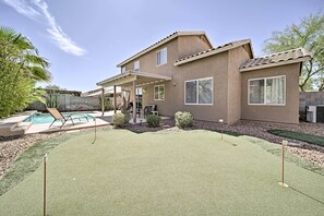 A house with a patio, a pool, and a green lawn. - 2 Mi to Goodyear Ballpark! Home w/ Poolside Oasis (Goodyear)