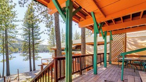 A wooden deck with a view of a lake and trees. - Waterfront Truckee Cabin on Donner Lake! (Truckee)