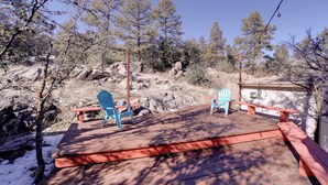 A wooden deck with two blue Adirondack chairs and a small wooden structure. - 2 Mi to Whiskey Row: Tranquil Getaway w/ Deck! (Prescott)