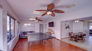A spacious room with a ping pong table, ceiling fans, a sofa, and a dining area with chairs. - 2 Mi to Whiskey Row: Tranquil Getaway w/ Deck! (Prescott)