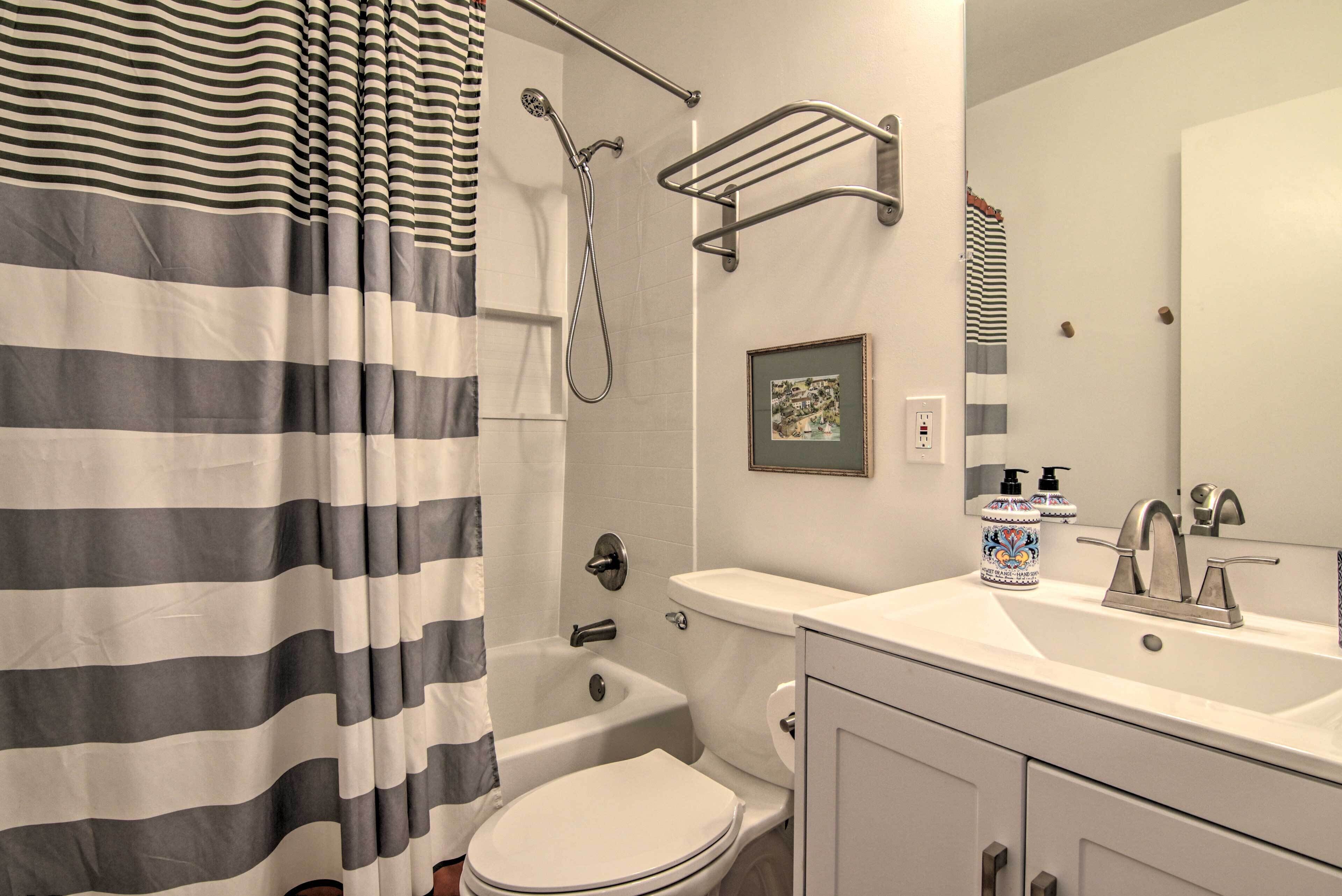 A bathroom with a bathtub, toilet, and sink.