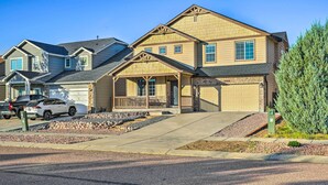 A two-story residential house with a front porch, garage, and a driveway. - Spacious Springs Home + Patio ~ 10 Mi to Dtwn (Colorado Springs)