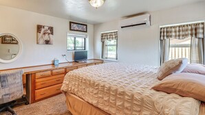 A bedroom with a bed, a dresser, a television, and a window with curtains. - 3 Mi to Lake! Roosevelt Retreat w/ Fire Pit (Roosevelt)