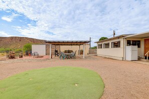 A covered outdoor area with a table and chairs, a barbecue grill, and a building with a refrigerator. - 3 Mi to Lake! Roosevelt Retreat w/ Fire Pit (Roosevelt)