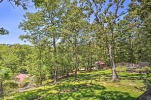 Escape to a serene natural retreat surrounded by trees and a grassy area.